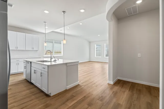 a kitchen with stainless steel appliances granite countertop a sink stove and cabinets