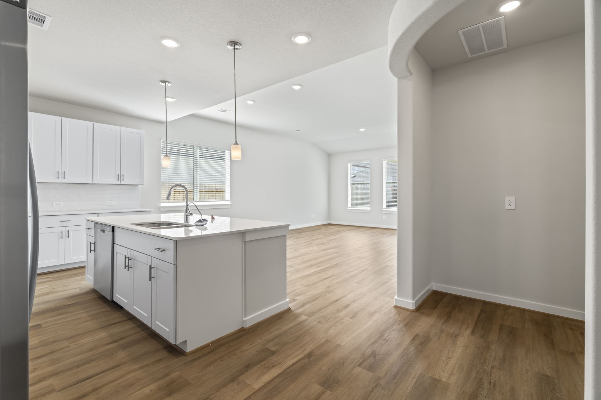 6606 Lenwood Lane Rosharon, TX 77583 - Photo 15 of 33 a kitchen with a sink wooden floor and white cabinets