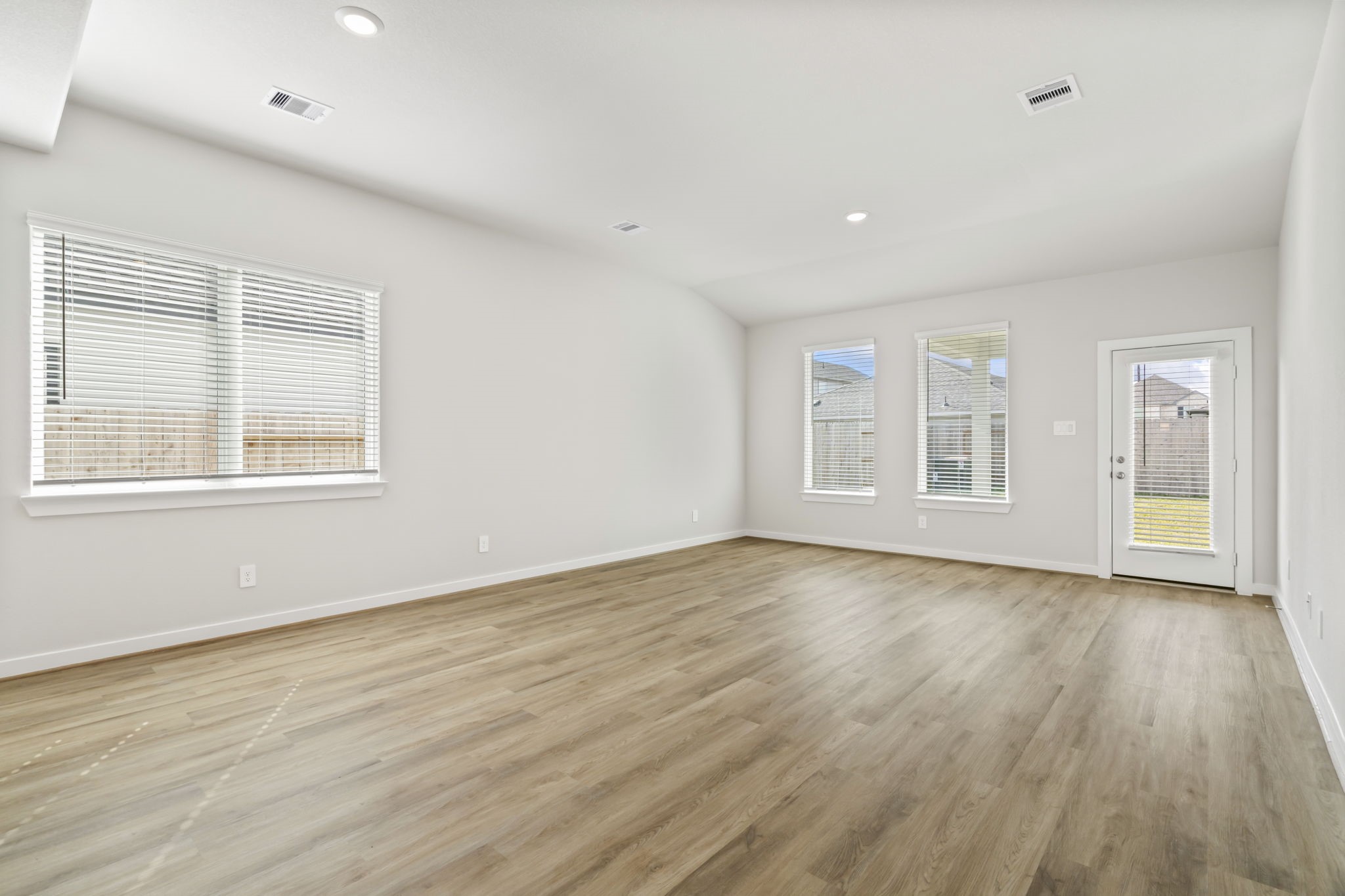 6606 Lenwood Lane Rosharon, TX 77583 - Photo 17 of 33 a view of an empty room with wooden floor and windows