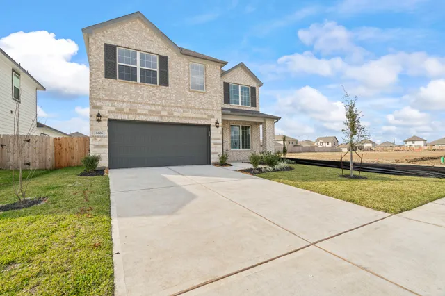 a front view of a house with a garden and pathway
