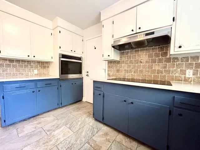 a kitchen with stainless steel appliances wooden cabinets and a sink