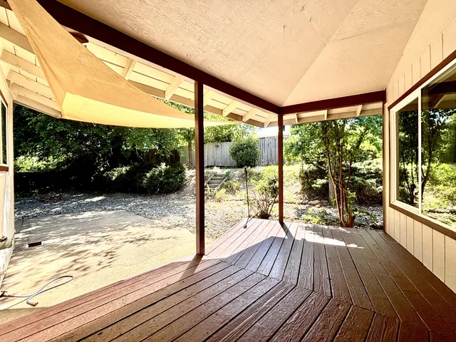 a view of a balcony with floor to ceiling windows wooden floor and outdoor space