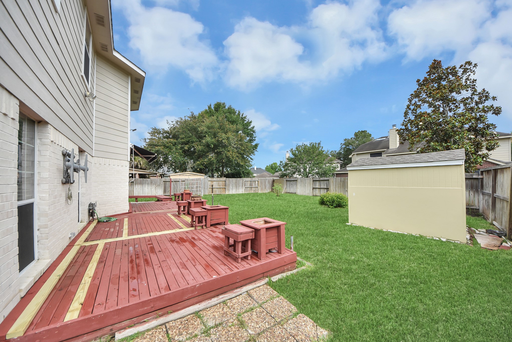 14103 Imperial Wood Lane Rosharon, TX 77583 - Photo 31 of 36 Oversized backyard with extended patio deck, storage shed, and room to roam