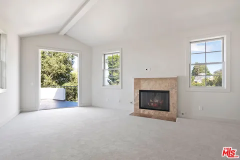 a bathroom with a granite countertop double vanity and a large mirror