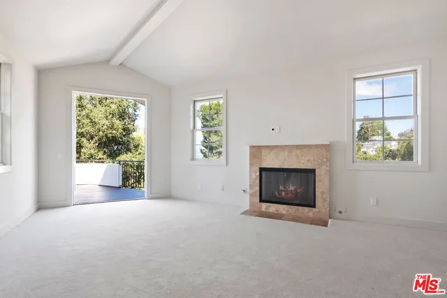 a bathroom with a granite countertop double vanity and a large mirror