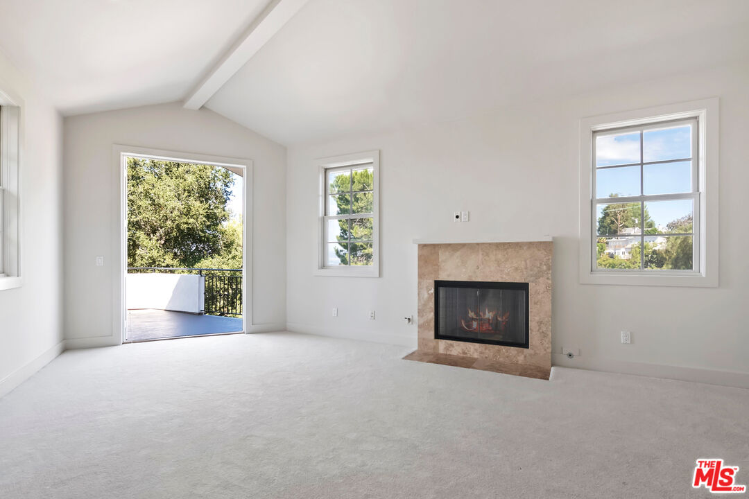 23550 Valley View Road Calabasas, CA 91302 - Photo 11 of 24 an empty room with windows and fireplace