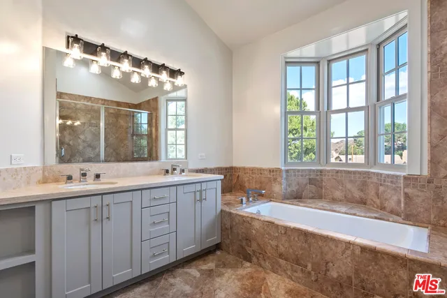 a bath tub sitting in a bathroom next to a window