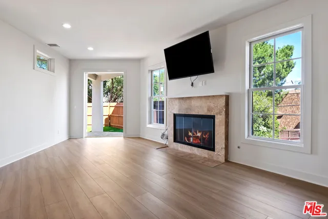 a view of a livingroom with a fireplace a window and a fireplace