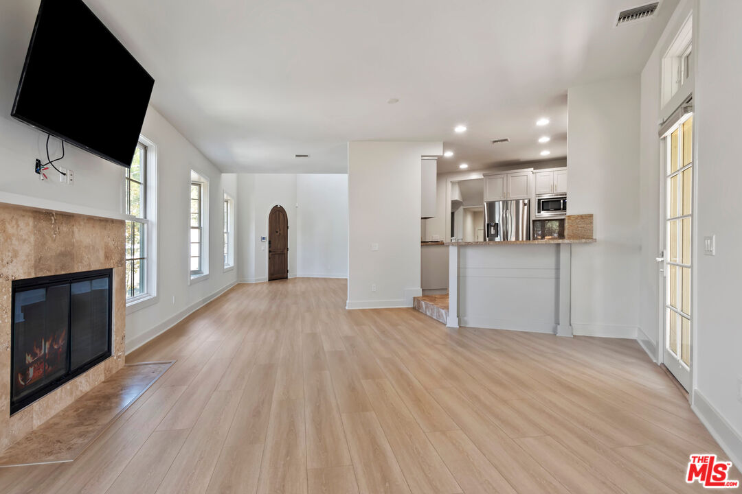 23550 Valley View Road Calabasas, CA 91302 - Photo 4 of 24 a view of a kitchen with a sink and a fireplace