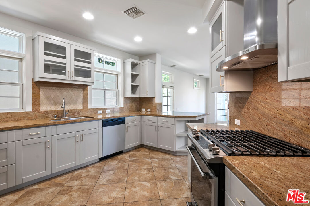 23550 Valley View Road Calabasas, CA 91302 - Photo 6 of 24 a kitchen with stainless steel appliances granite countertop a stove a sink and a microwave