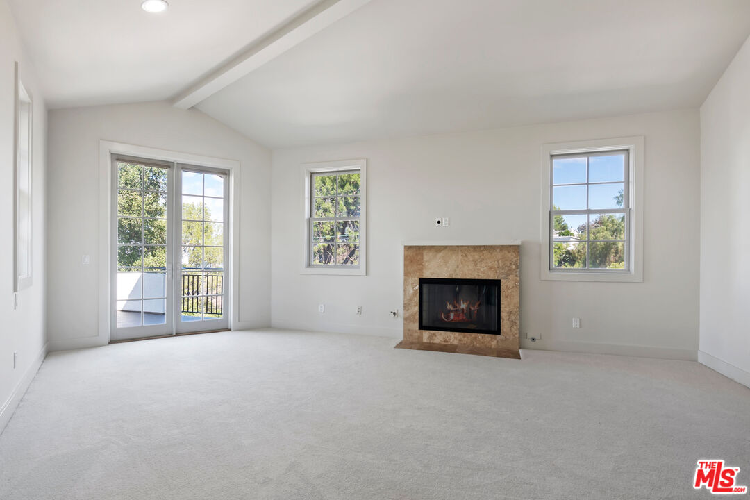 23550 Valley View Road Calabasas, CA 91302 - Photo 10 of 24 an empty room with a fireplace and window