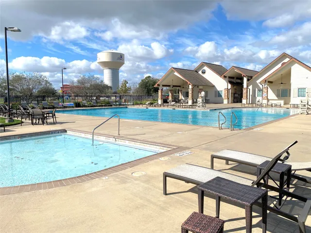a view of a swimming pool with lounge chairs