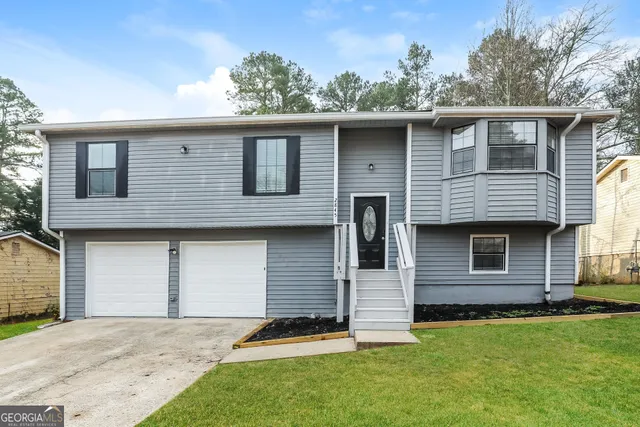 a front view of a house with a garden