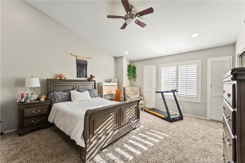 a bedroom with a bed a dresser and a window