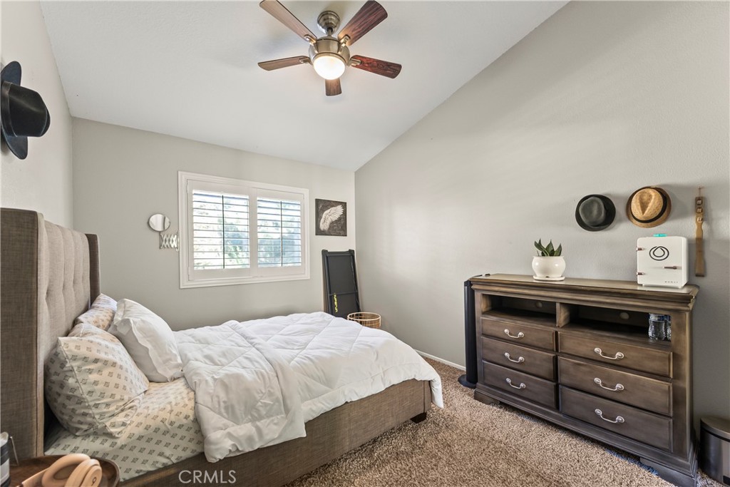 22617 Copper Hill Drive, Unit 121 Saugus, CA 91350 - Photo 14 of 24 a bedroom with a bed and a chandelier