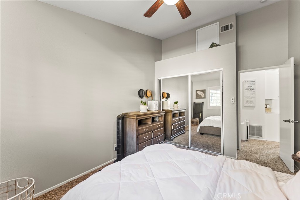 22617 Copper Hill Drive, Unit 121 Saugus, CA 91350 - Photo 16 of 24 a bedroom with a bed and a dresser