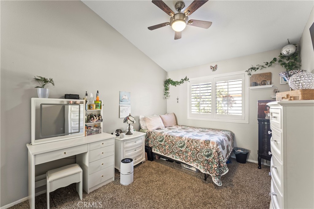 22617 Copper Hill Drive, Unit 121 Saugus, CA 91350 - Photo 17 of 24 a bedroom with a bed dresser and a window