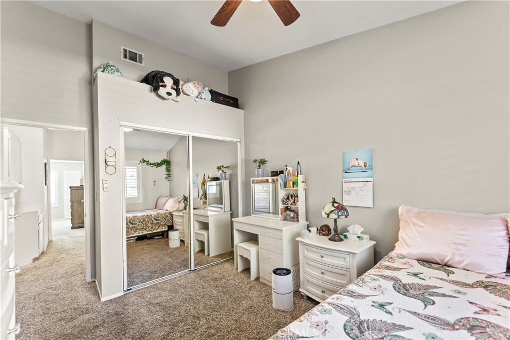 22617 Copper Hill Drive, Unit 121 Saugus, CA 91350 - Photo 18 of 24 a bedroom with a bed and a chandelier