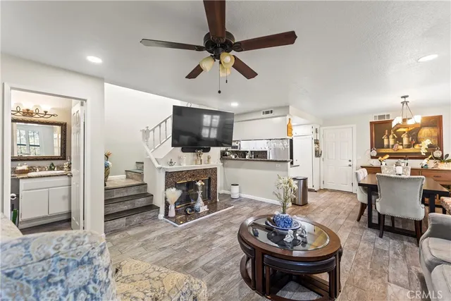 a living room with furniture a fireplace and a flat screen tv