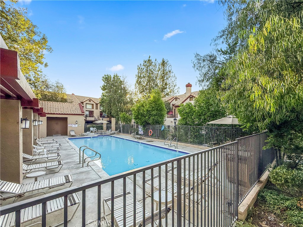 22617 Copper Hill Drive, Unit 121 Saugus, CA 91350 - Photo 21 of 24 a view of a balcony with wooden floor and fence
