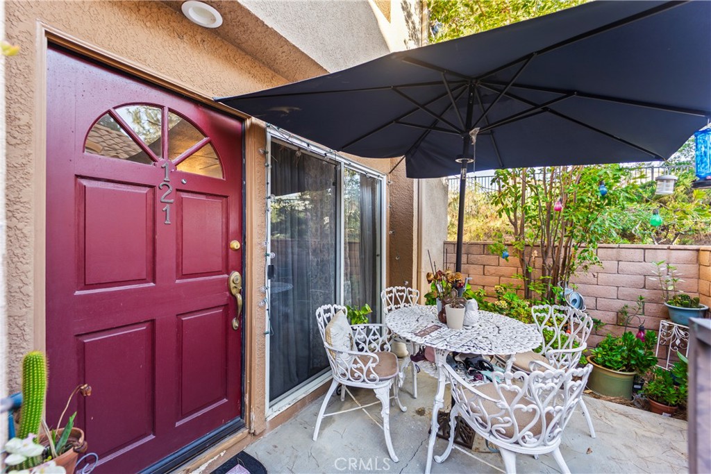 22617 Copper Hill Drive, Unit 121 Saugus, CA 91350 - Photo 23 of 24 a patio with a yard table and chairs