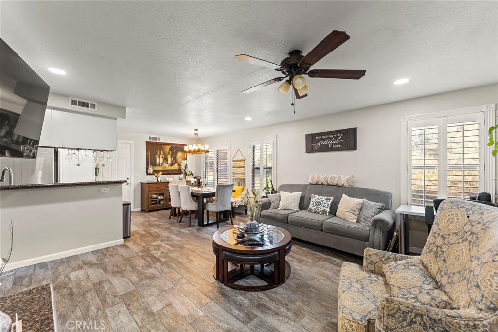 22617 Copper Hill Drive, Unit 121 Saugus, CA 91350 - Photo 3 of 24 a living room with furniture and a large window