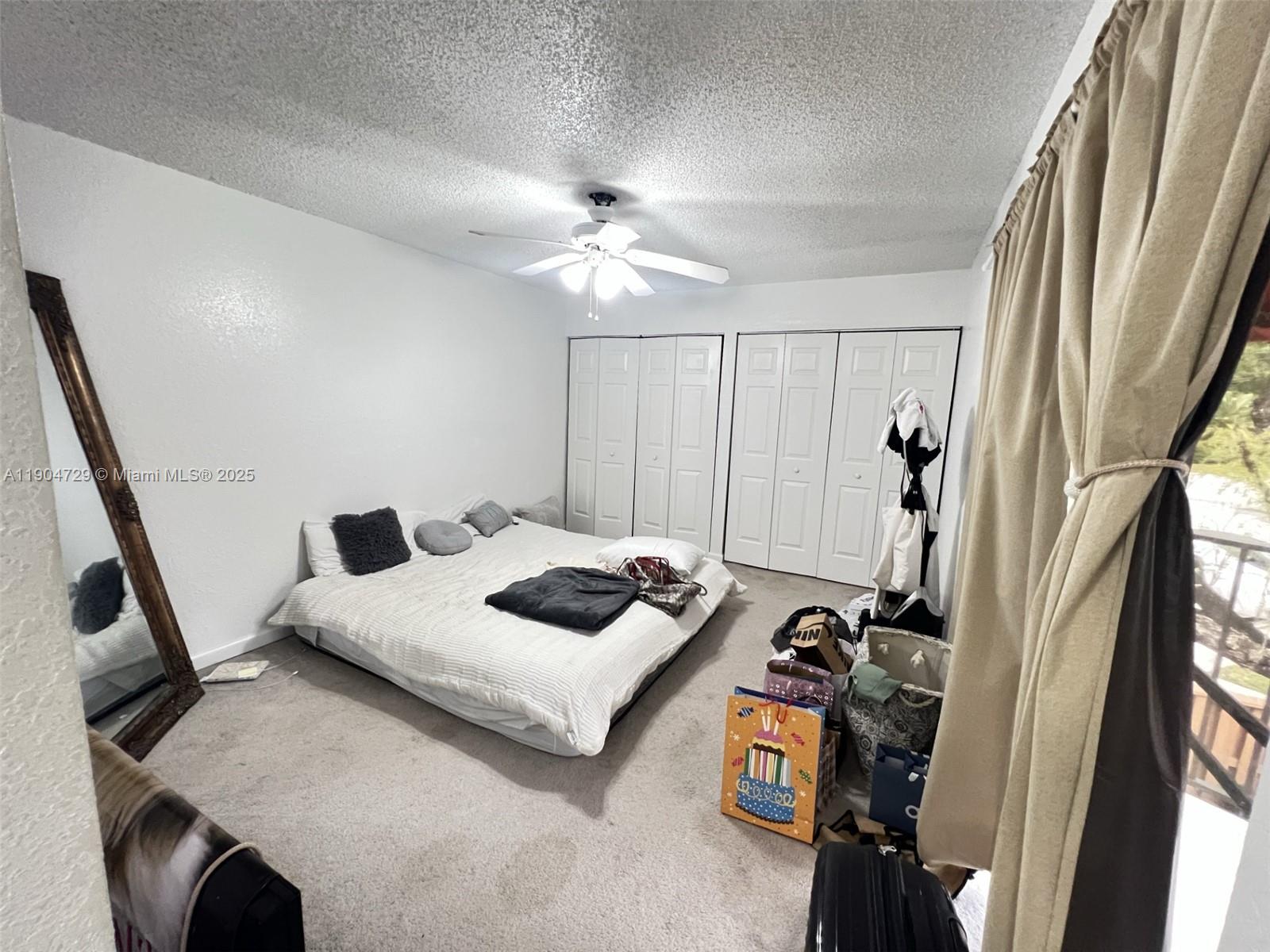 8116 Severn Drive, Unit C Boca Raton, FL 33433 - Photo 12 of 19 a bedroom with furniture and a chandelier