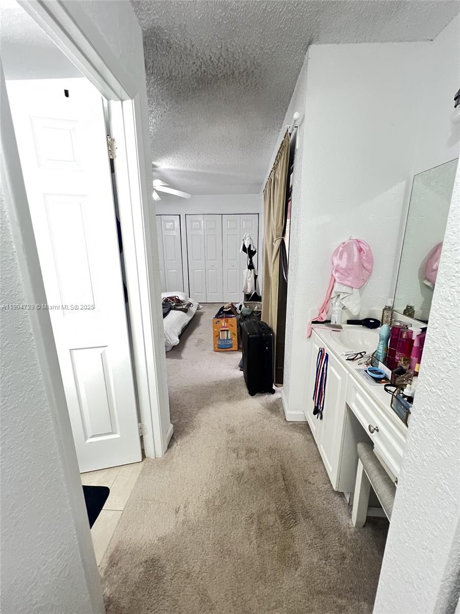 8116 Severn Drive, Unit C Boca Raton, FL 33433 - Photo 14 of 19 a bed room with a bed and a mirror