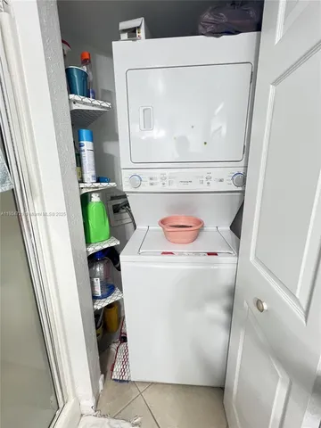 a view of a garden with a bench in the garden