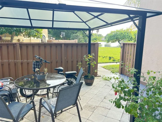 a backyard of a house with table and chairs