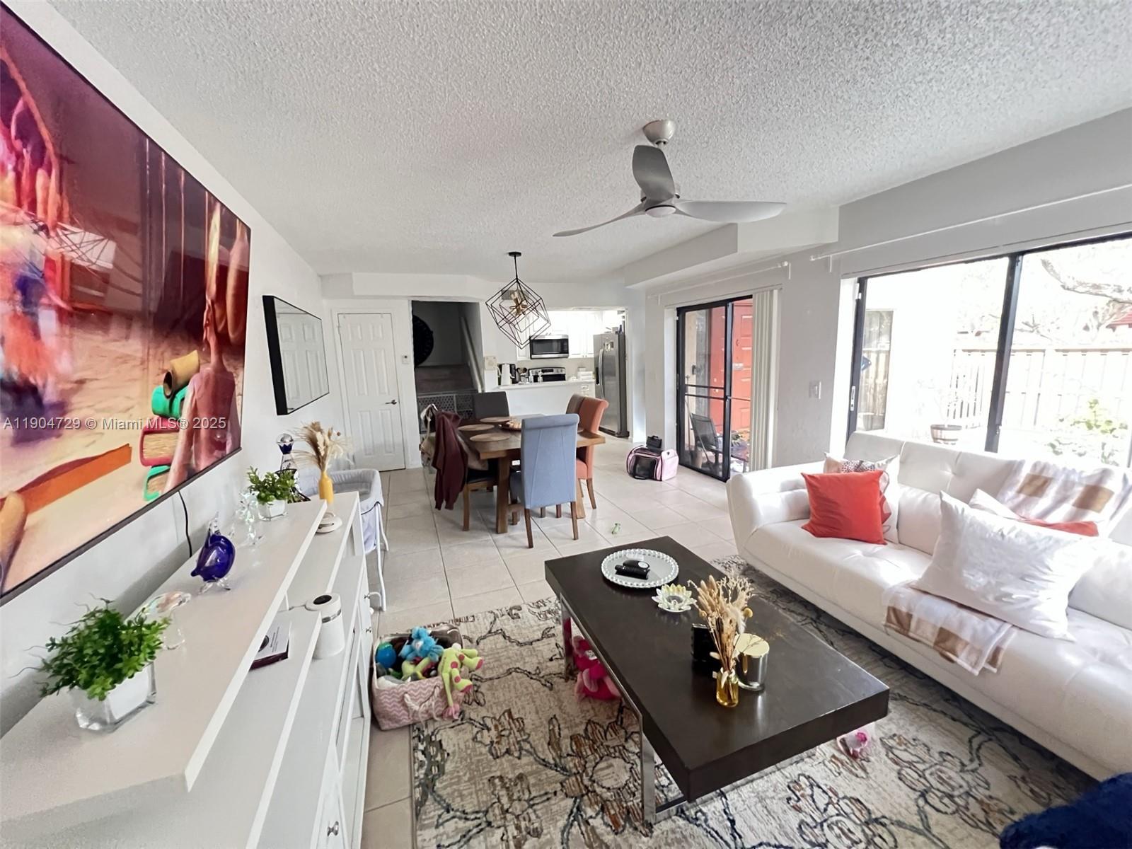 8116 Severn Drive, Unit C Boca Raton, FL 33433 - Photo 8 of 19 a living room with furniture fireplace and a large window