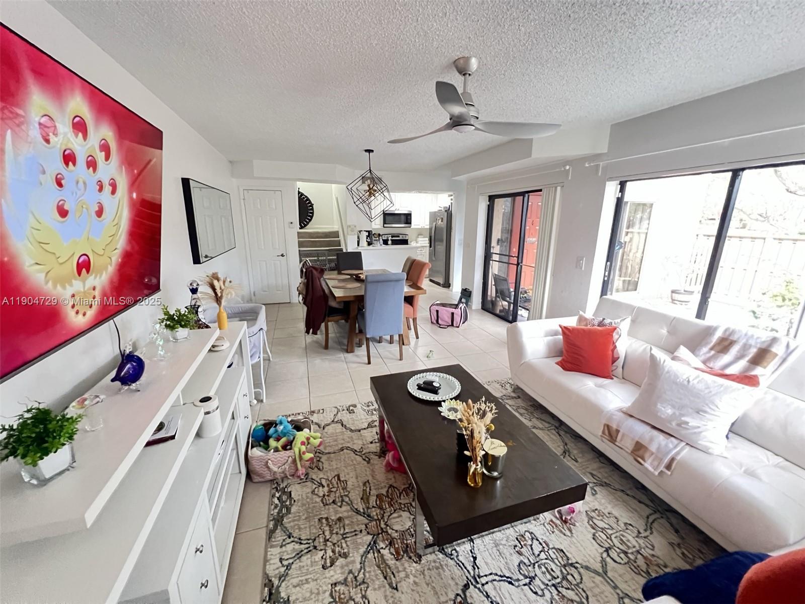 8116 Severn Drive, Unit C Boca Raton, FL 33433 - Photo 9 of 19 a living room with furniture and flat screen tv