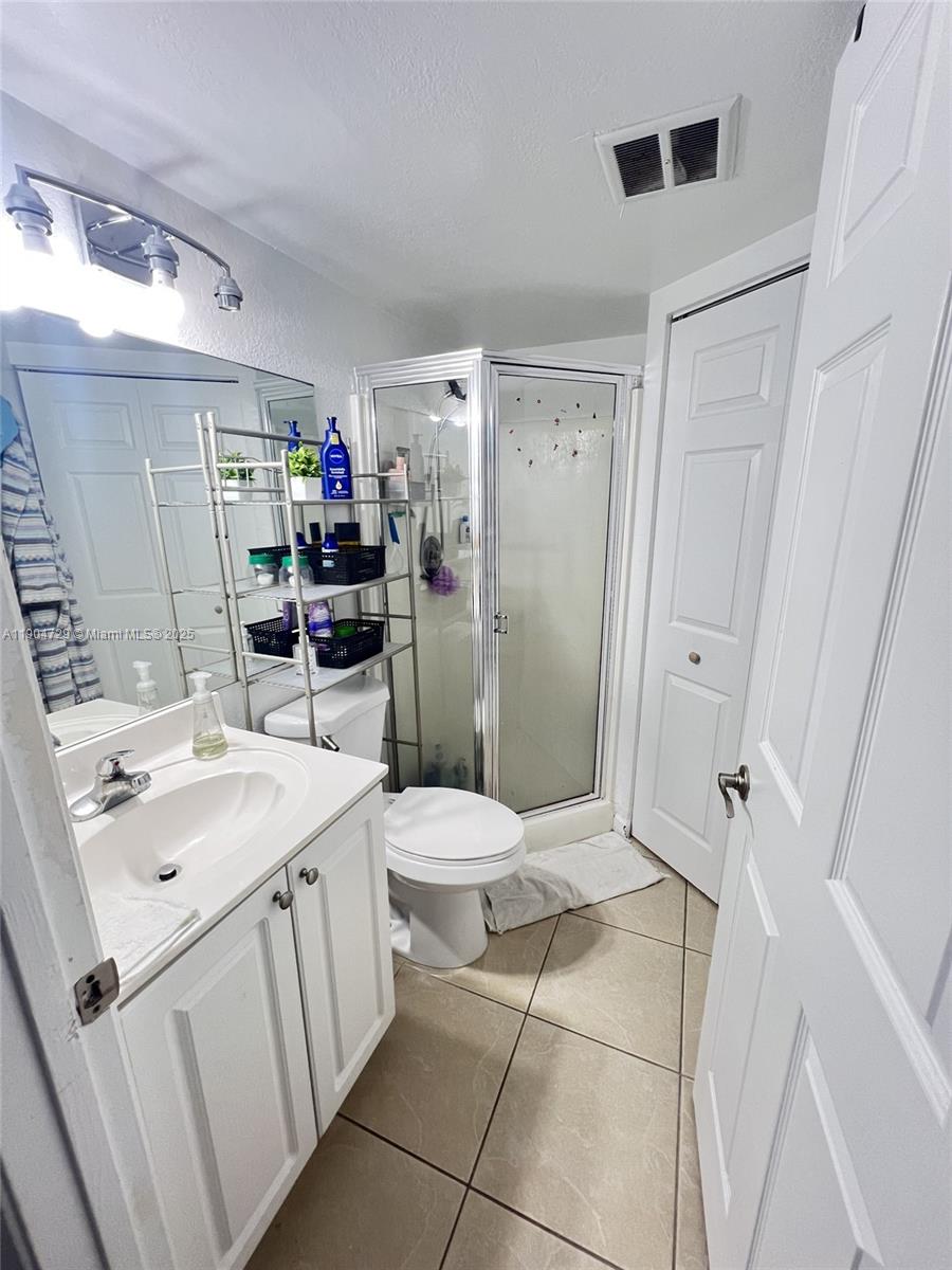 8116 Severn Drive, Unit C Boca Raton, FL 33433 - Photo 10 of 19 a bathroom with a sink toilet and shower