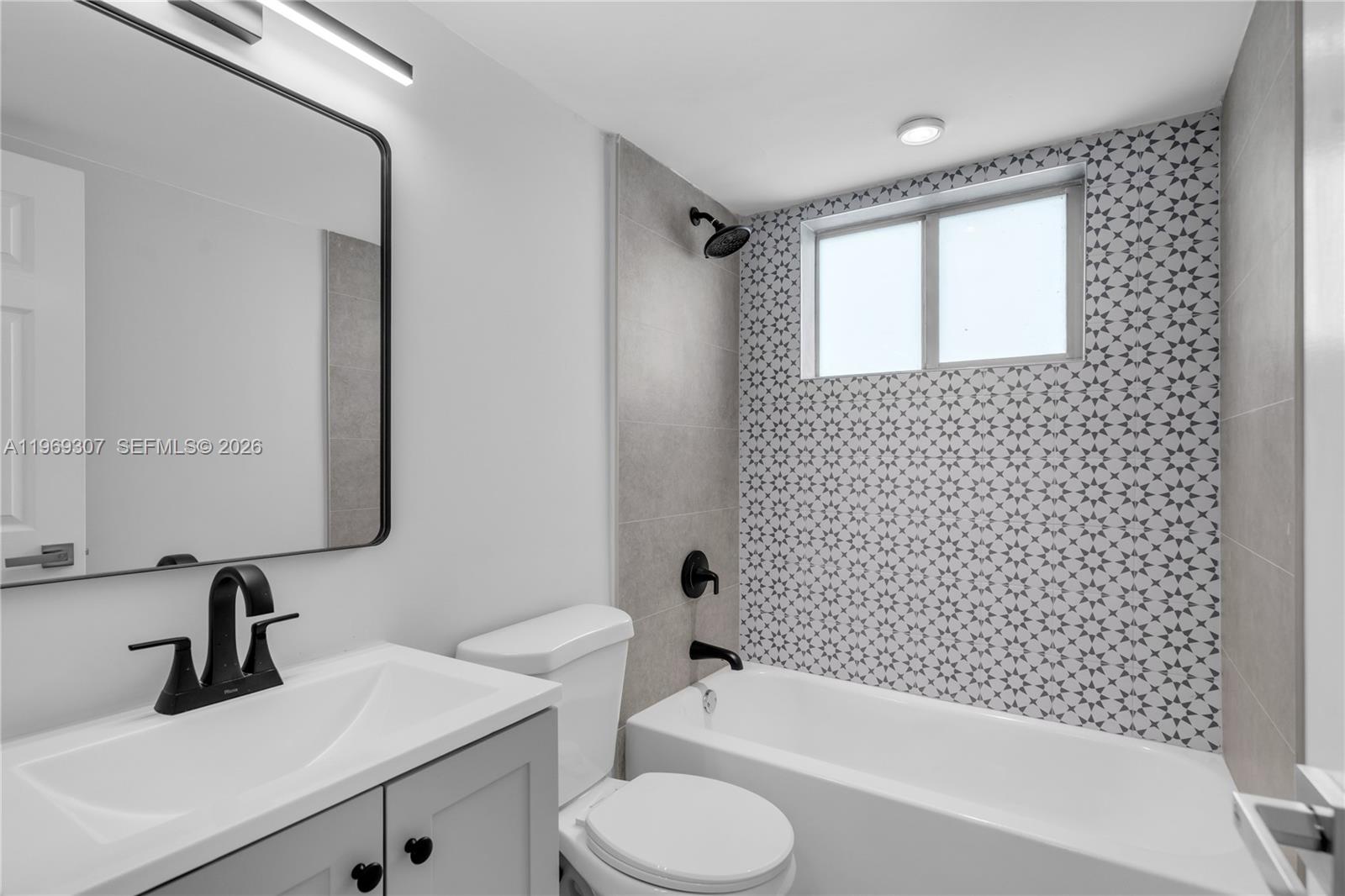 560 Northeast 63rd Street, Unit 3 Miami, FL 33138 - Photo 20 of 23 a bathroom with a sink toilet and shower