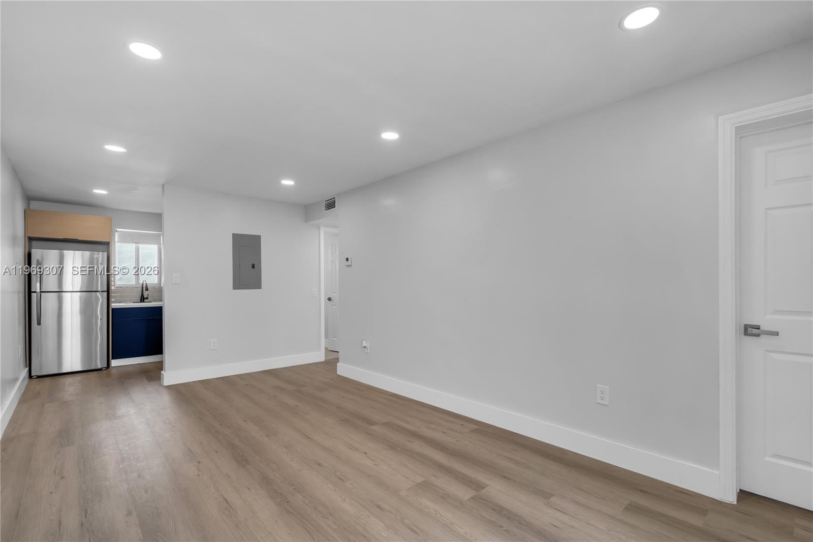 560 Northeast 63rd Street, Unit 3 Miami, FL 33138 - Photo 2 of 23 an empty room with wooden floor and windows
