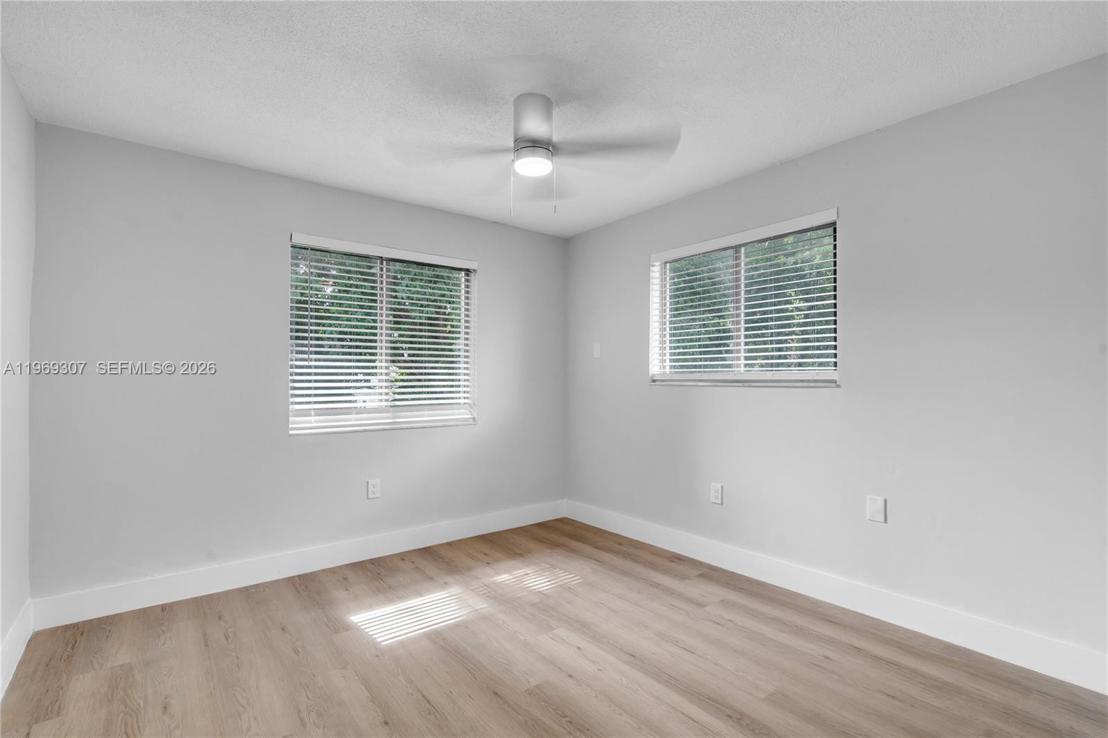560 Northeast 63rd Street, Unit 3 Miami, FL 33138 - Photo 23 of 23 a view of an empty room with wooden floor and a window