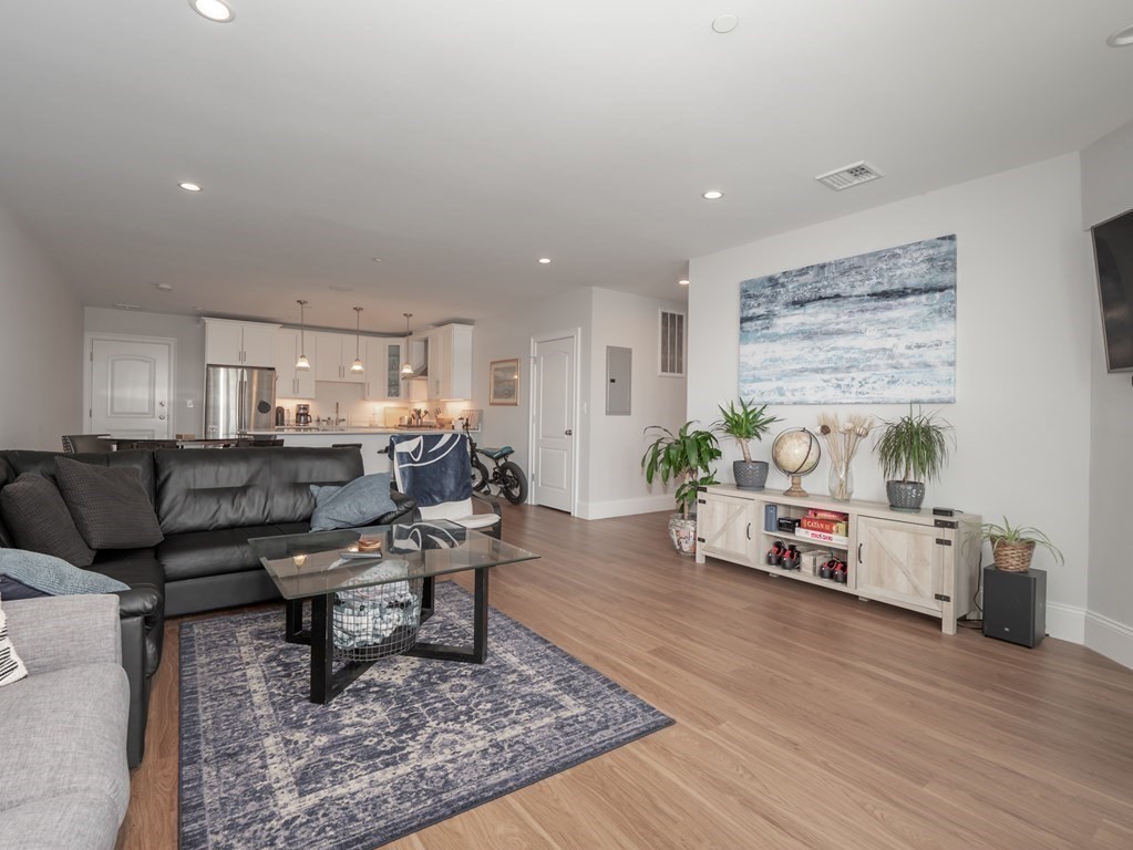 45 L Street, Unit 21 Boston, MA 02127 - Photo 11 of 23 a living room with furniture and a wooden floor