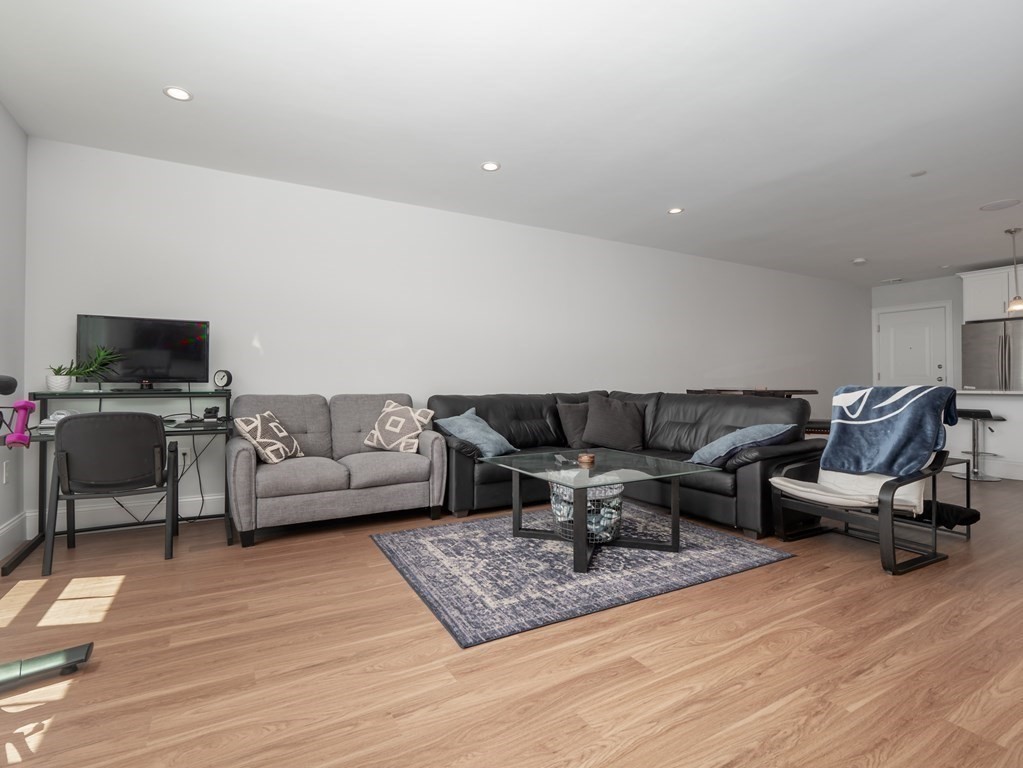 45 L Street, Unit 21 Boston, MA 02127 - Photo 12 of 23 a living room with furniture and a flat screen tv