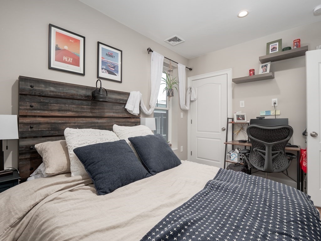 45 L Street, Unit 21 Boston, MA 02127 - Photo 15 of 23 a bedroom with a bed and wooden floor