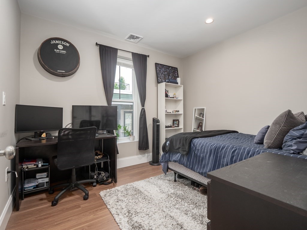 45 L Street, Unit 21 Boston, MA 02127 - Photo 16 of 23 a bedroom with a bed and a desk