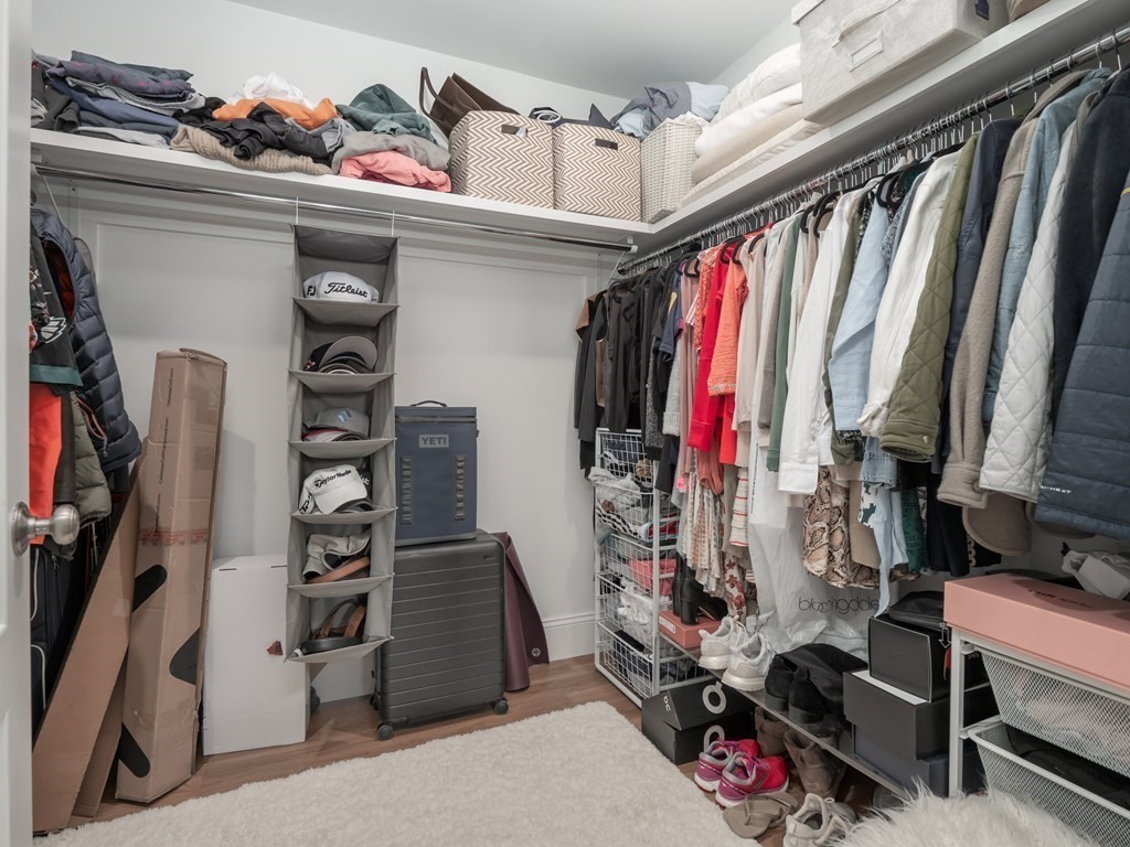 45 L Street, Unit 21 Boston, MA 02127 - Photo 17 of 23 a view of walk in closet with clothes and shoes