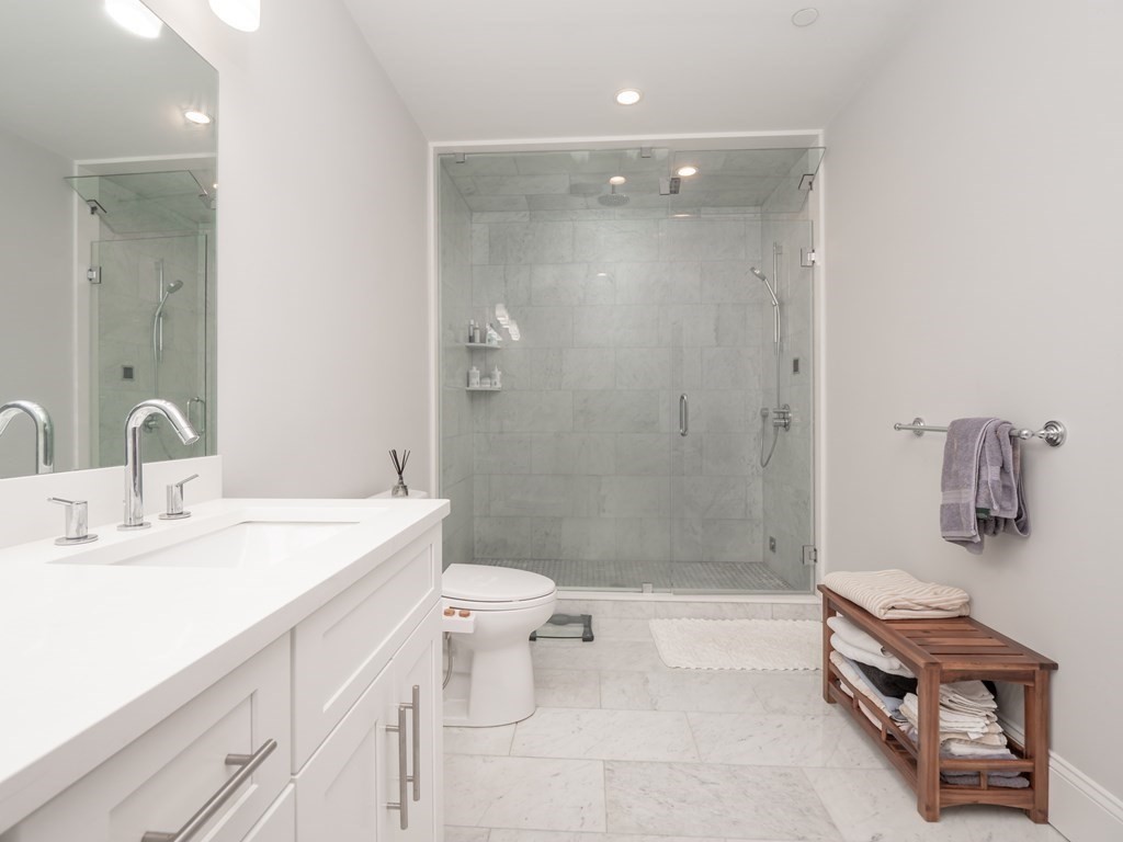 45 L Street, Unit 21 Boston, MA 02127 - Photo 20 of 23 a bathroom with a sink a toilet and shower