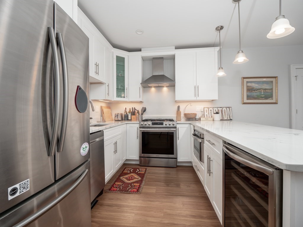 45 L Street, Unit 21 Boston, MA 02127 - Photo 3 of 23 a kitchen with stainless steel appliances a refrigerator sink and cabinets