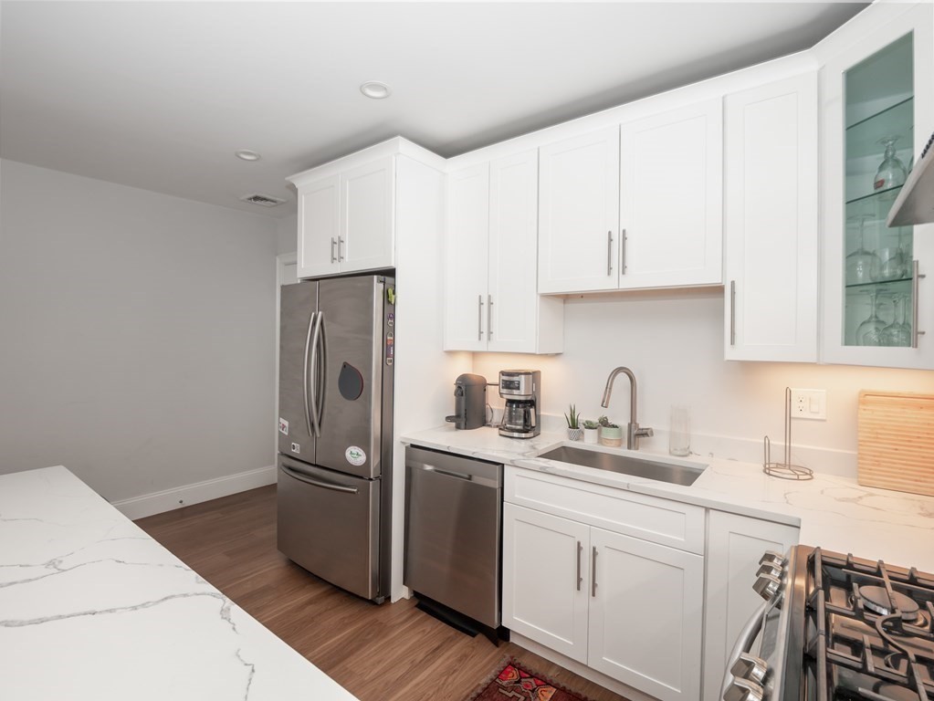 45 L Street, Unit 21 Boston, MA 02127 - Photo 4 of 23 a kitchen with stainless steel appliances a refrigerator sink and cabinets