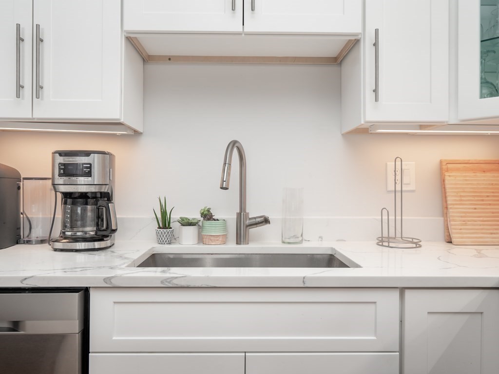 45 L Street, Unit 21 Boston, MA 02127 - Photo 6 of 23 a kitchen with granite countertop white cabinets and a sink