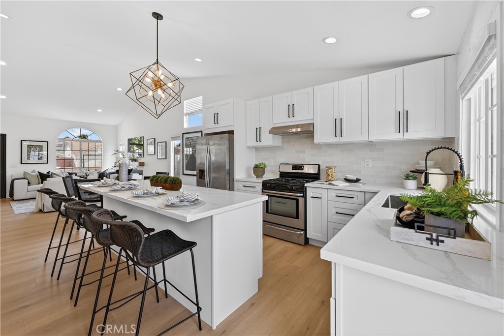 1263 Cornerstone Way Corona, CA 92878 - Photo 7 of 20 a kitchen with a table chairs stove and cabinets