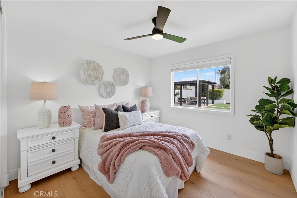1263 Cornerstone Way Corona, CA 92878 - Photo 8 of 20 a bedroom with a bed and a potted plant on the dresser