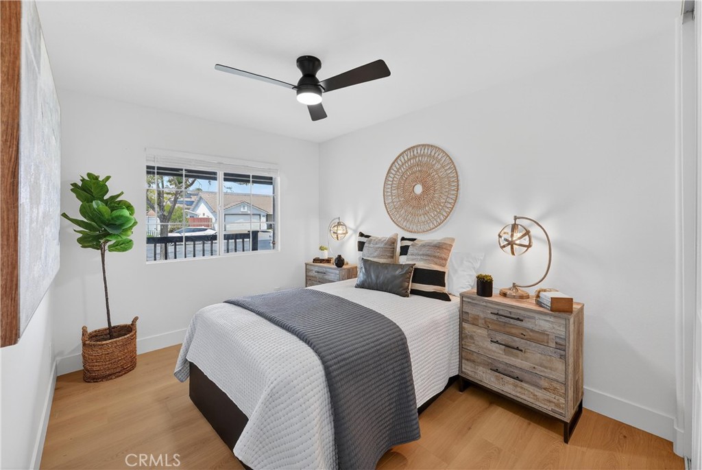 1263 Cornerstone Way Corona, CA 92878 - Photo 9 of 20 a bedroom with a bed a chandelier and a potted plant