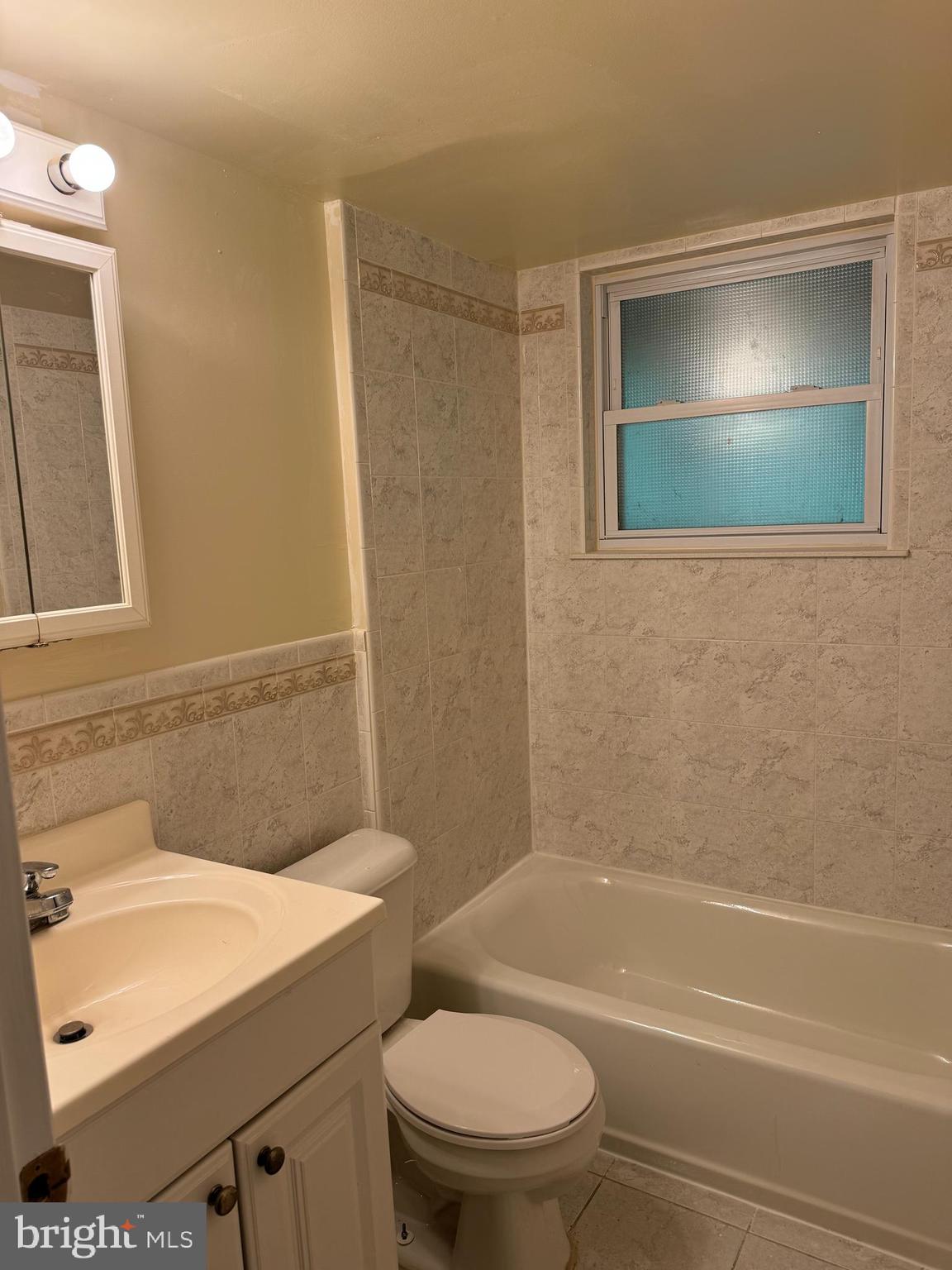 9401 Cheltenham Avenue Clinton, MD 20735 - Photo 11 of 16 a bathroom with a toilet a sink and bathtub
