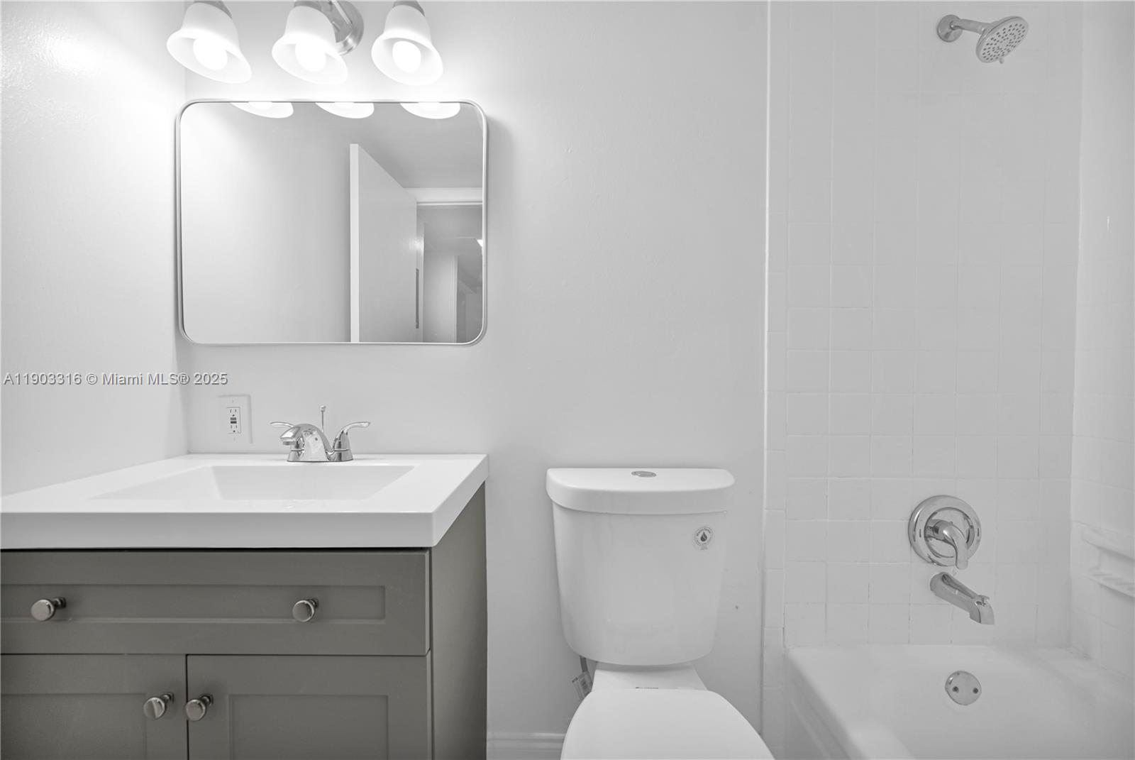 7550 Stirling Road, Unit A202 Davie, FL 33024 - Photo 20 of 27 a bathroom with a toilet sink and mirror